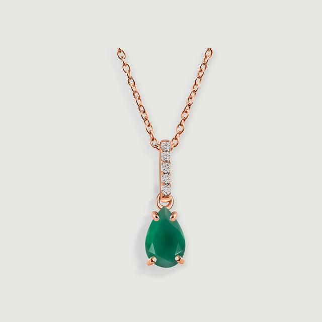A rose gold chain holds a green teardrop pendant with four prongs and a clear-stone bail.