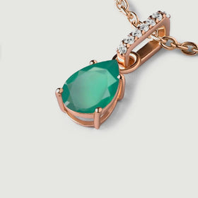 An angled green pendant reveals its raised rose gold setting beside a curved chain.