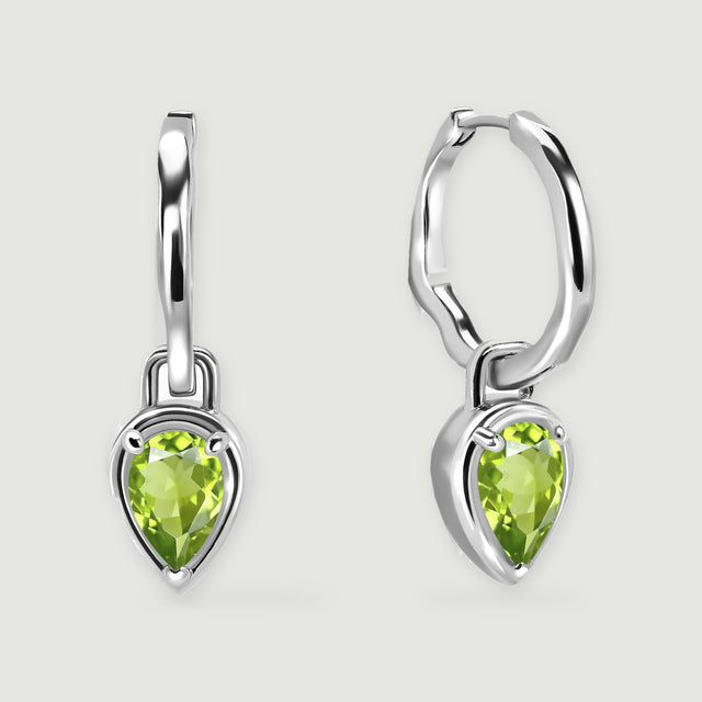 Two silver-tone hoop earrings with pear-shaped green peridot drops are centered on a light gray background.