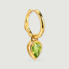 An angled yellow gold-tone hoop reveals its curved profile, hinged closure, and suspended green peridot drop.