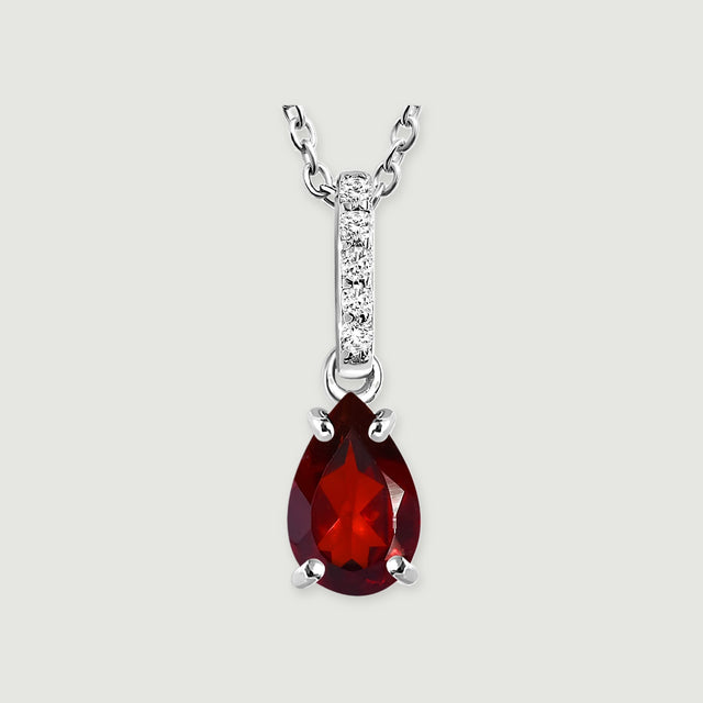A sterling silver chain joins a narrow five-stone bail above a deep red teardrop garnet on a light gray background.