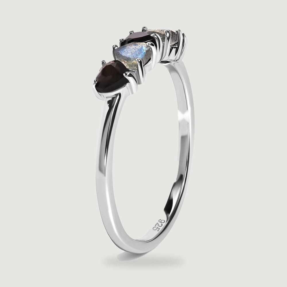 An upright side view shows the slender silver band and raised prong settings beneath the heart-shaped stones.