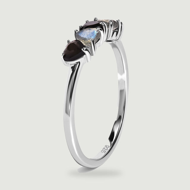 An upright side view shows the slender silver band and raised prong settings beneath the heart-shaped stones.