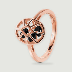 An angled rose gold ring shows its slim curved band and raised oval cage with black stones.