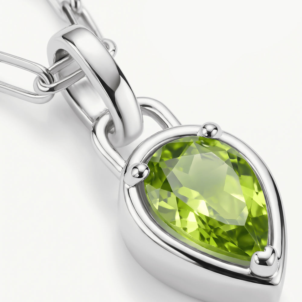 A close view shows the green gemstone facets, rounded silver-tone prongs, and polished pendant bail.