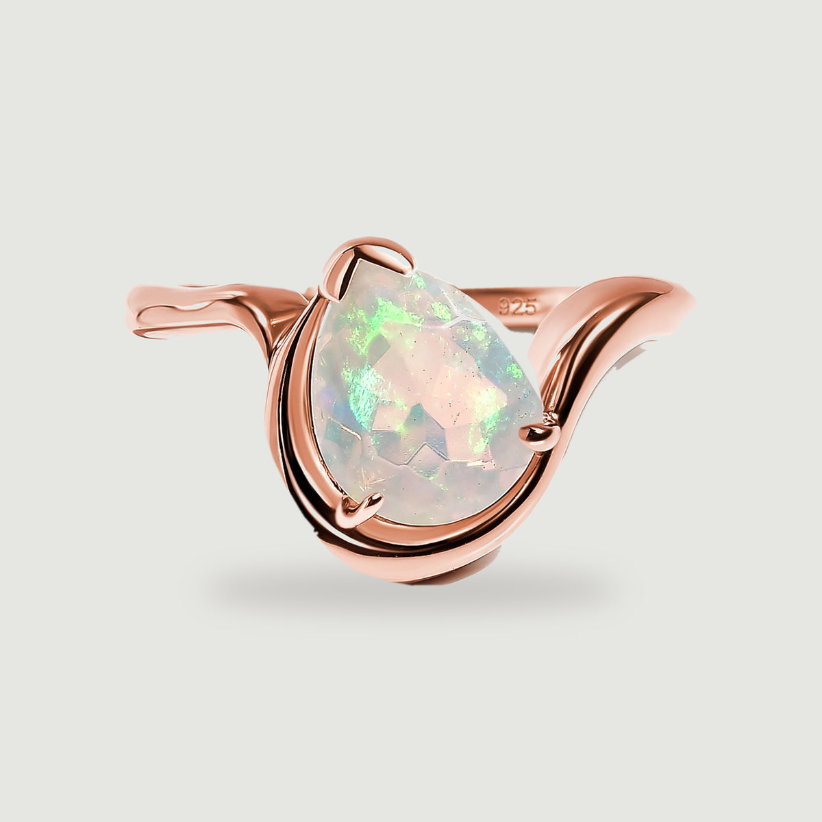 A pear-shaped opal sits within the curved rose gold band on a light gray background.