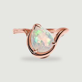 A pear-shaped opal sits within the curved rose gold band on a light gray background.