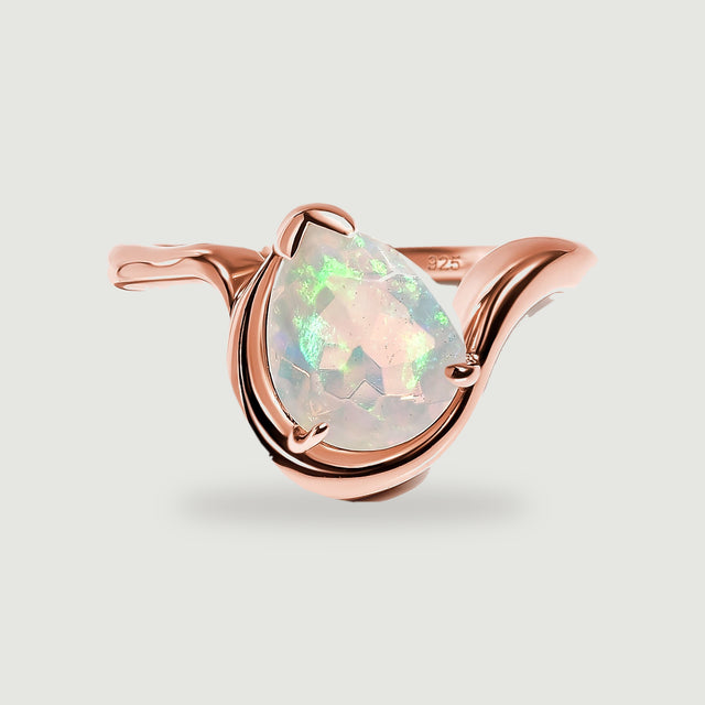 A pear-shaped opal sits within the curved rose gold band on a light gray background.