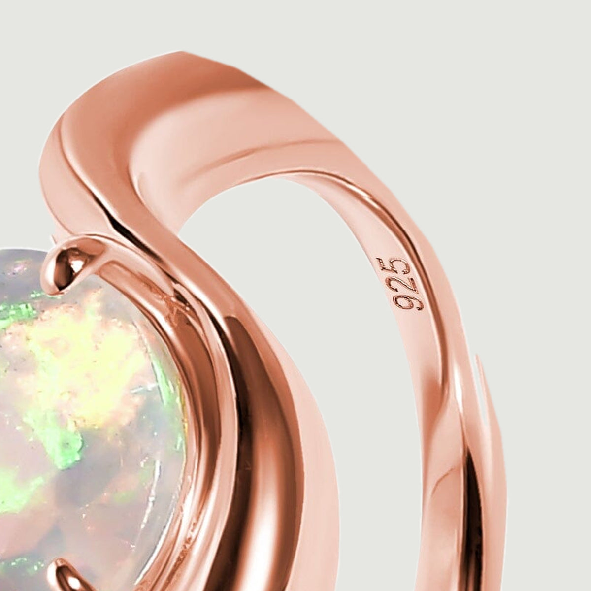 A close view shows the smooth rose gold band and the 925 stamp on its inner surface.