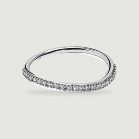 A polished white gold ring displays its open center and diamond-set front edge.