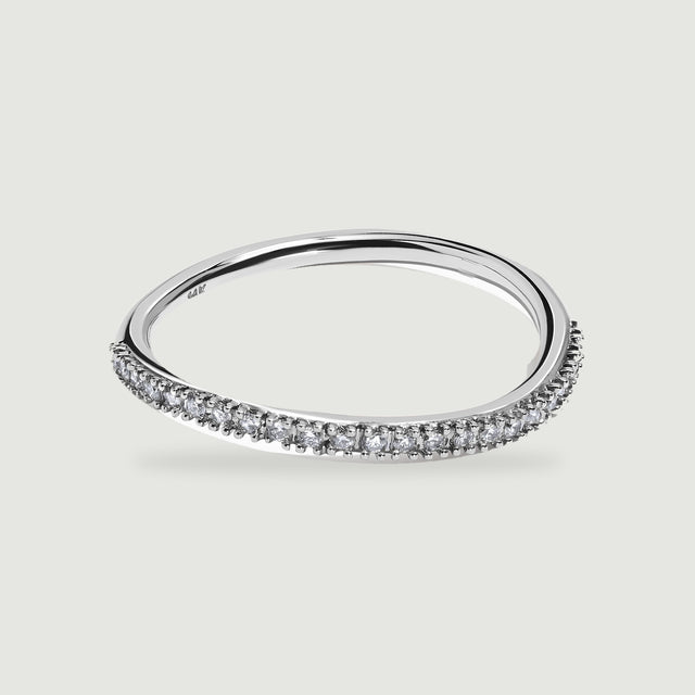 A polished white gold ring displays its open center and diamond-set front edge.