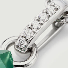 A diagonal silver bail carries five round clear stones above a polished connecting ring.