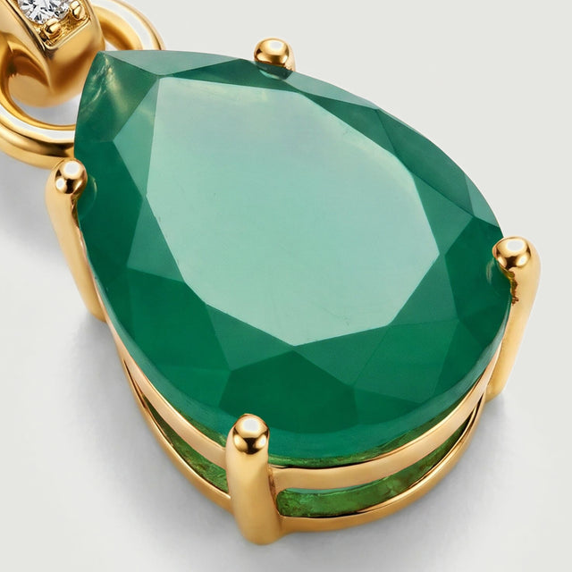 Four rounded gold prongs hold a green pear-shaped stone with broad reflective facets.
