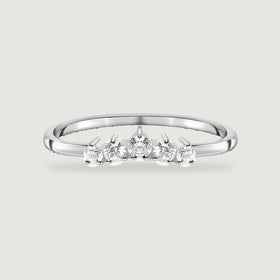 A complete sterling silver ring with five round white zircon stones rests on a light gray background.