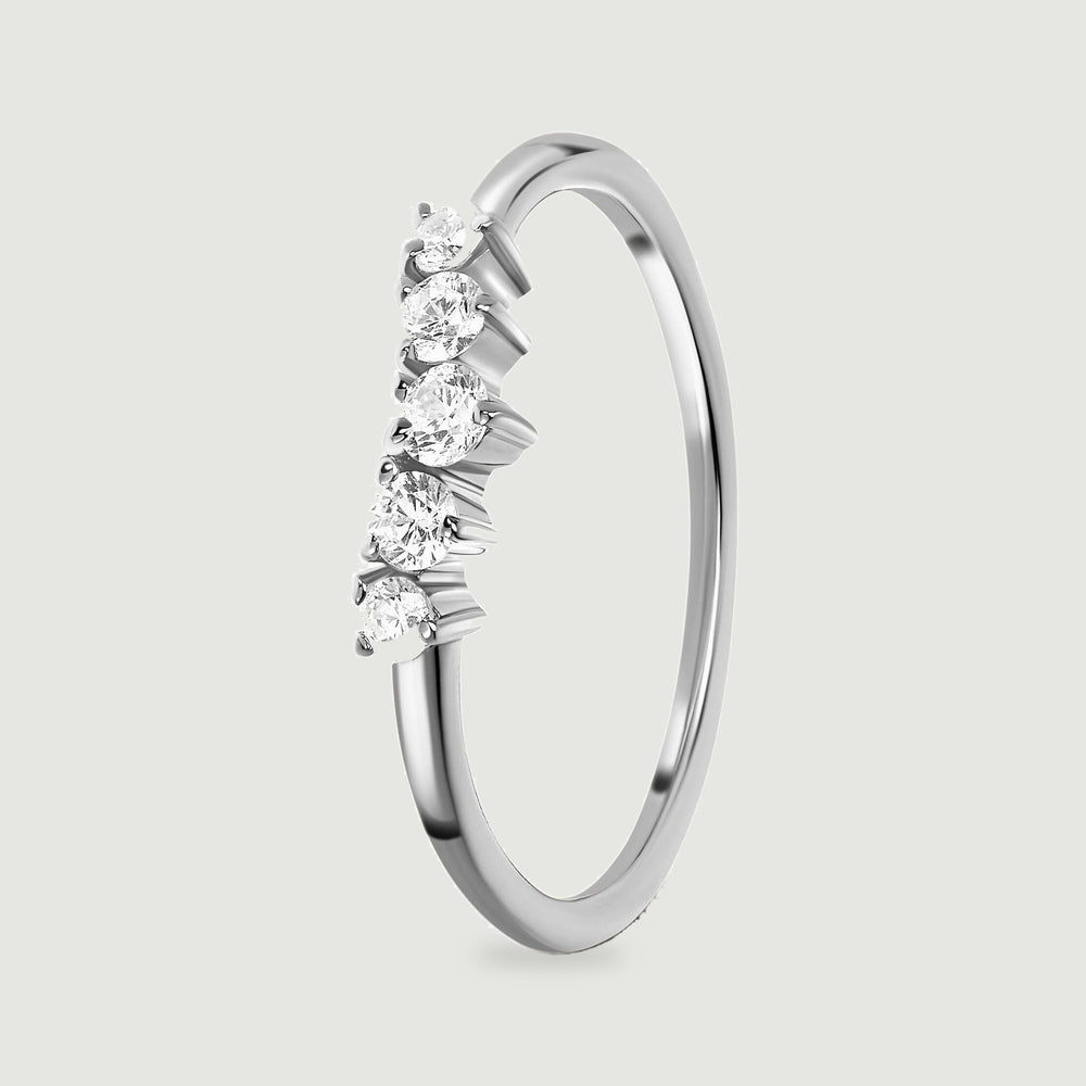 An upright silver ring reveals the raised settings beneath five white zircon stones and its slim polished band.