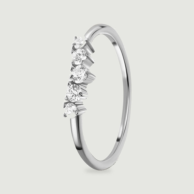 An upright silver ring reveals the raised settings beneath five white zircon stones and its slim polished band.