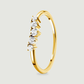The angled yellow gold vermeil ring shows its curved shank and the side walls of five zircon settings.