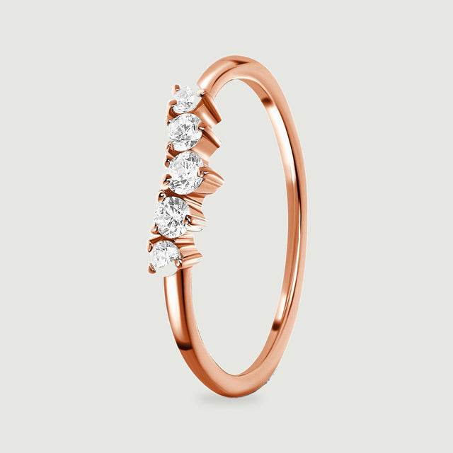 A side view of the rose gold vermeil ring displays five round stones above an open circular band.