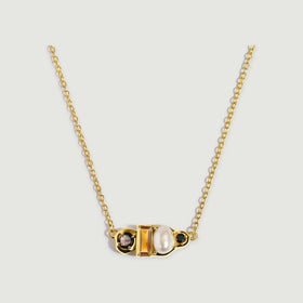 A yellow gold vermeil necklace presents a horizontal cluster of faceted amber citrine, a cream pearl and round dark gemstones.