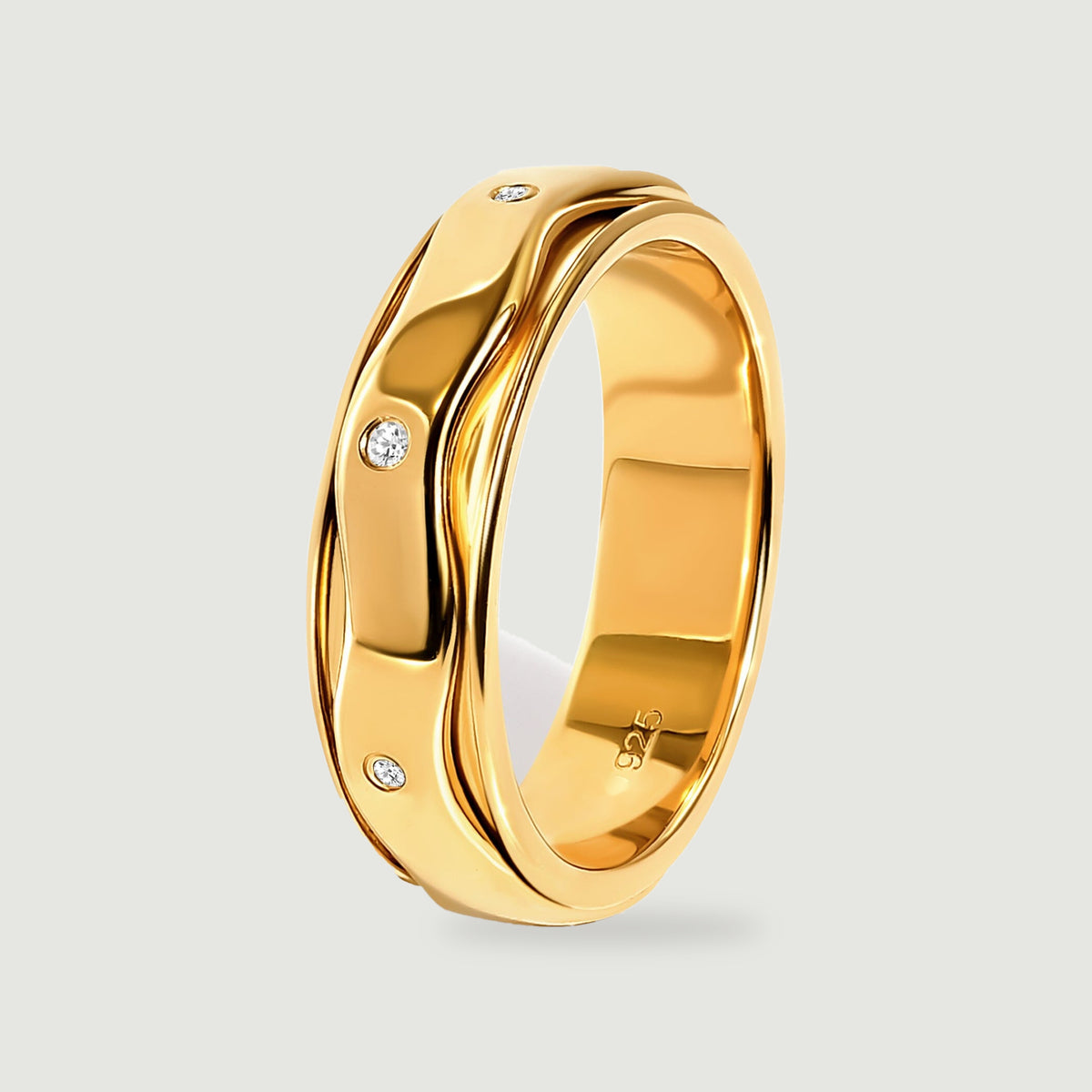 The yellow gold vermeil ring stands at an angle with white stones and polished curved edges visible from the side.