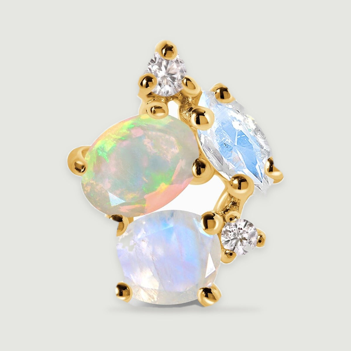 An enlarged yellow gold earring shows an oval opal beside faceted pale stones and round clear accents.
