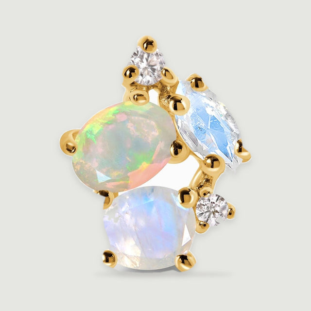 An enlarged yellow gold earring shows an oval opal beside faceted pale stones and round clear accents.