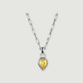 A white rhodium plated chain holds a pear-shaped citrine pendant on a pale grey background.