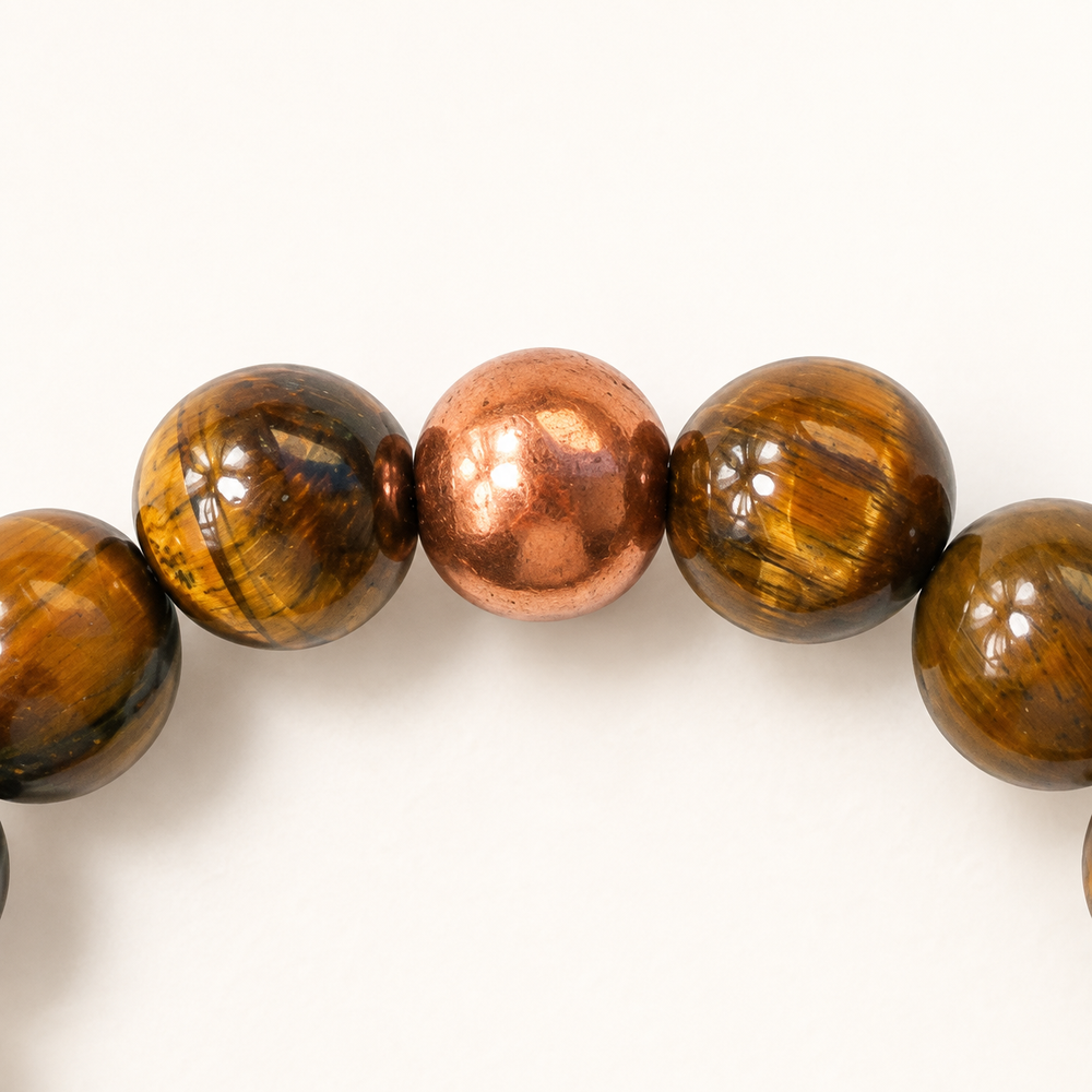 Golden Resolve tiger's eye and copper bead bracelet, detail of the copper accent and adjoining tiger’s eye beads; cropped from the same design view.