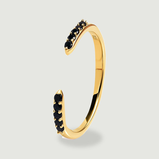An upright yellow gold vermeil band shows its curved profile and raised black stone settings.