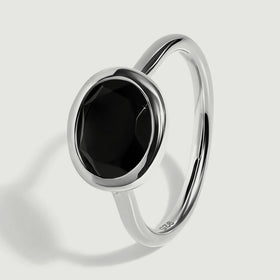 The sterling silver ring is shown upright at an angle with a narrow polished band.