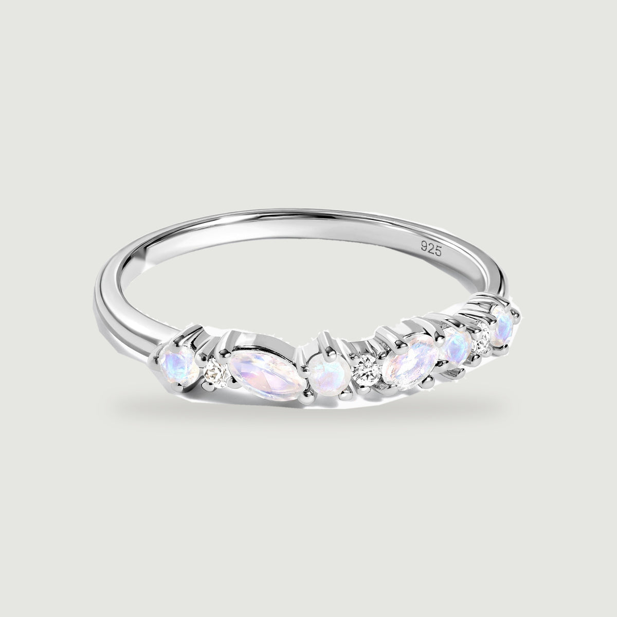 A sterling silver ring displays pale iridescent stones and small clear stones across its front.