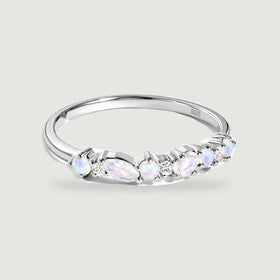 A sterling silver ring displays pale iridescent stones and small clear stones across its front.