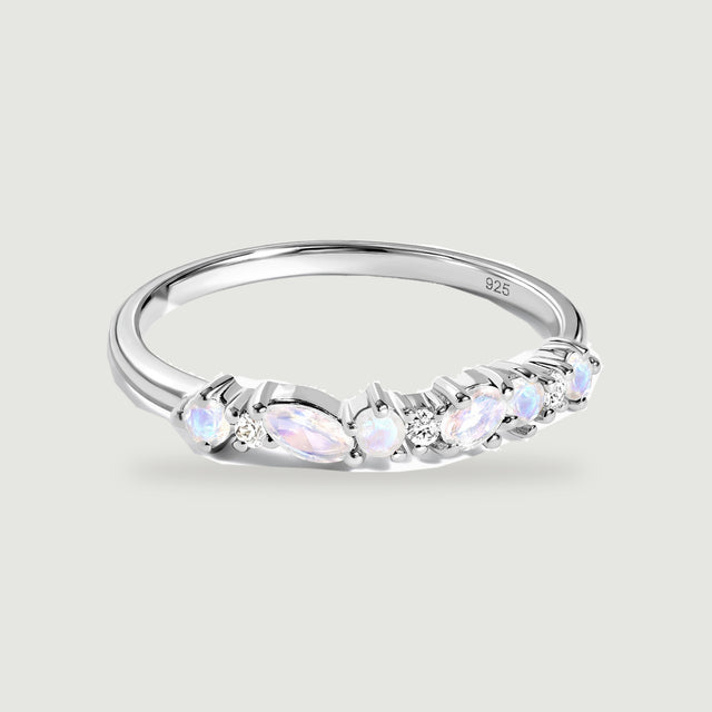 A sterling silver ring displays pale iridescent stones and small clear stones across its front.