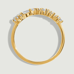 Raised yellow gold settings sit above a narrow polished band in this side view.