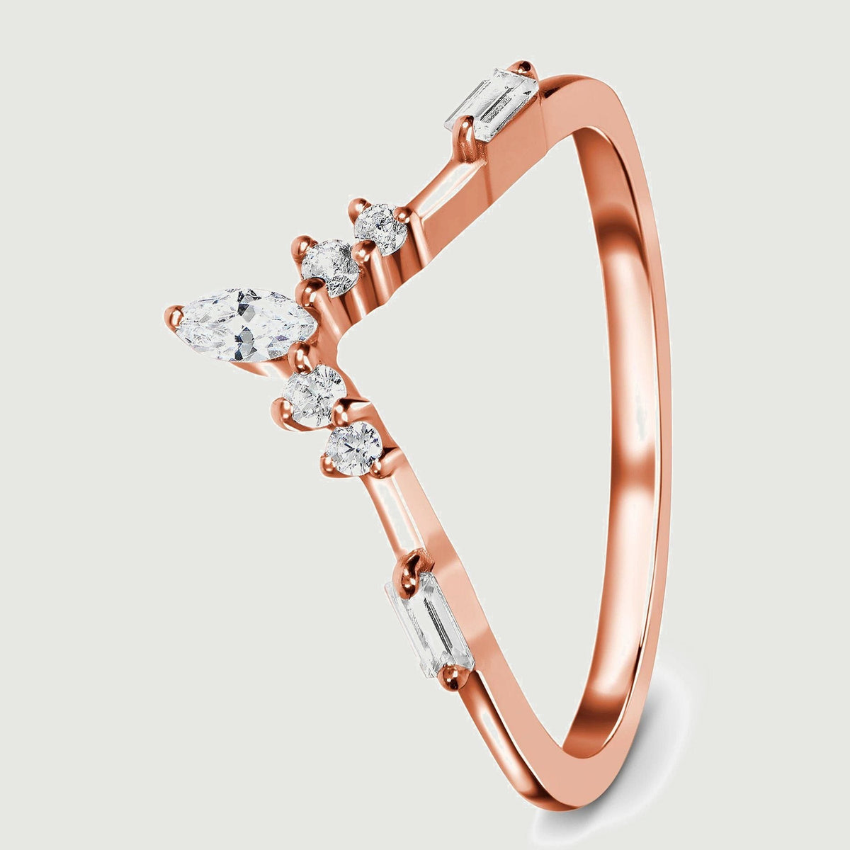 An angled rose gold band reveals the raised clear stones and its smooth curved shank.