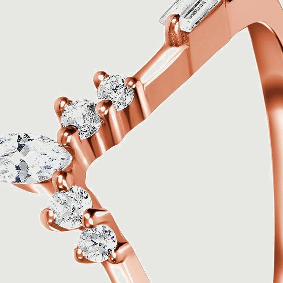 Clear faceted stones and rose gold prongs are visible along the sloping shoulder of the ring.