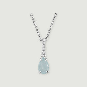 A silver chain frames a pale blue pear-shaped stone beneath a narrow row of round clear stones on light gray.