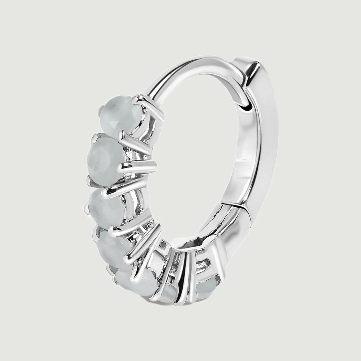 A single silver-toned aquamarine hoop is shown upright with its curved clasp visible.