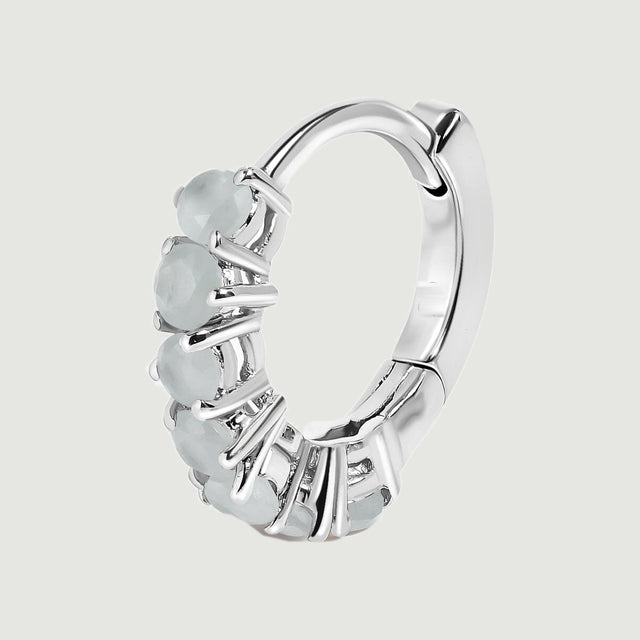 A single silver-toned aquamarine hoop is shown upright with its curved clasp visible.