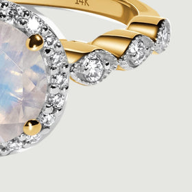 The right shoulder shows round diamonds and polished yellow gold beside the moonstone halo.