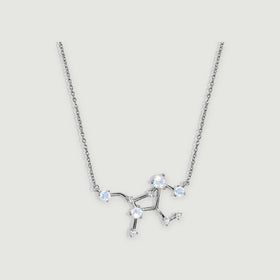 A sterling silver necklace with a branching pendant and four pale round moonstones rests on a light grey background.