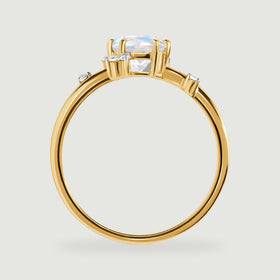 The yellow gold ring is shown from the side with a raised prong setting and an open circular band.