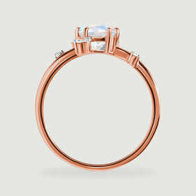 A side view of the rose gold ring reveals its elevated moonstone basket and narrow polished band.