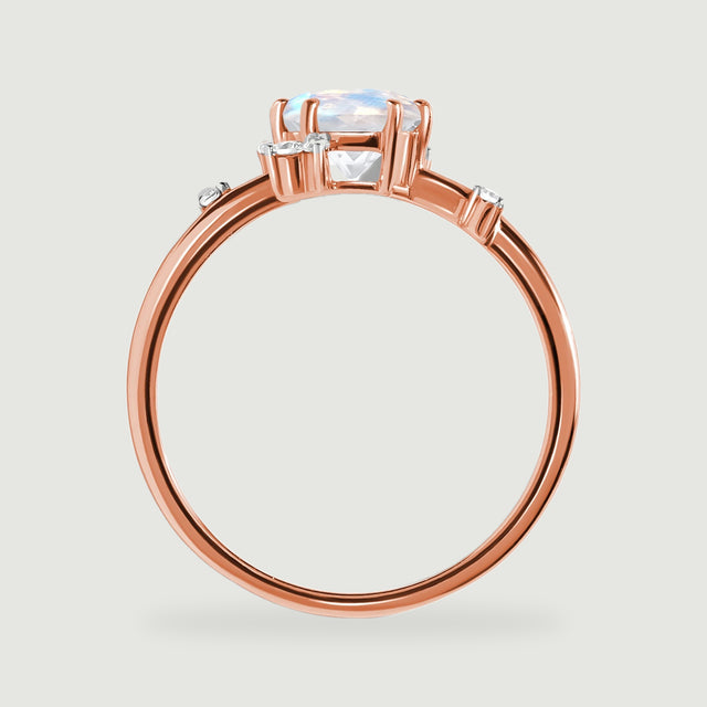 A side view of the rose gold ring reveals its elevated moonstone basket and narrow polished band.