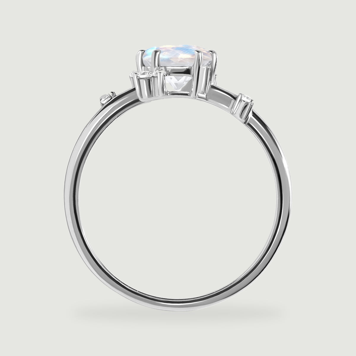 The white gold ring appears in profile with a raised oval stone and small diamond settings along the shoulders.