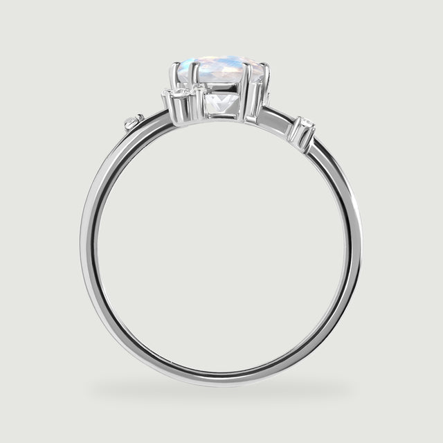The white gold ring appears in profile with a raised oval stone and small diamond settings along the shoulders.