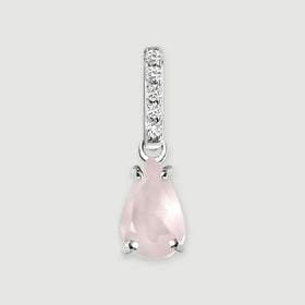 A pear-shaped pink rose quartz pendant hangs beneath a row of five clear stones in silver on a light gray background.