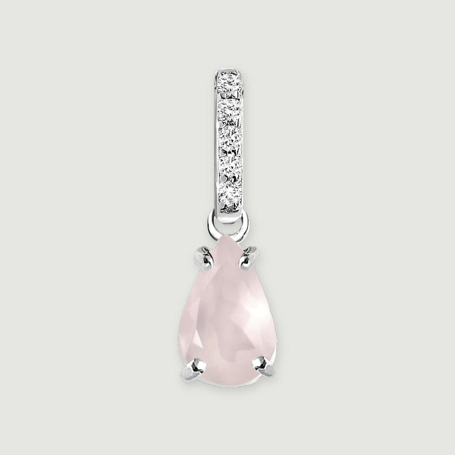 A pear-shaped pink rose quartz pendant hangs beneath a row of five clear stones in silver on a light gray background.