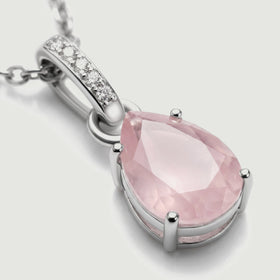 A close view shows the pink gemstone facets, silver prongs, and five clear stones along the curved bail.