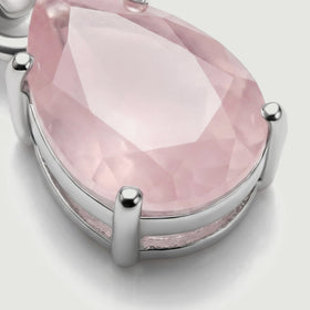 The lower side of the silver pendant reveals its open basket setting and rounded prongs around the pink stone.